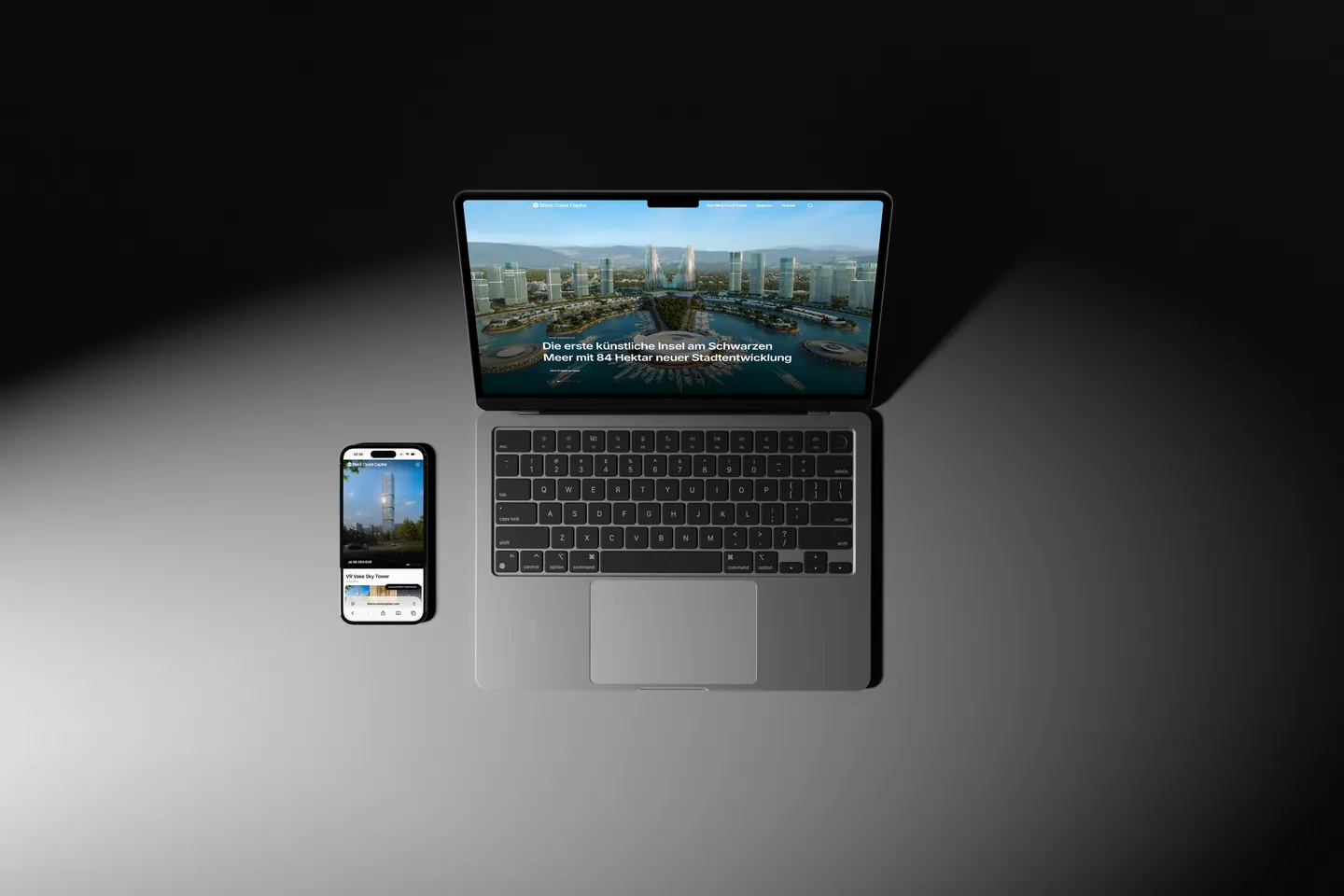 Startseite von Black Coast Capital auf einem Laptop mit Smartphone daneben